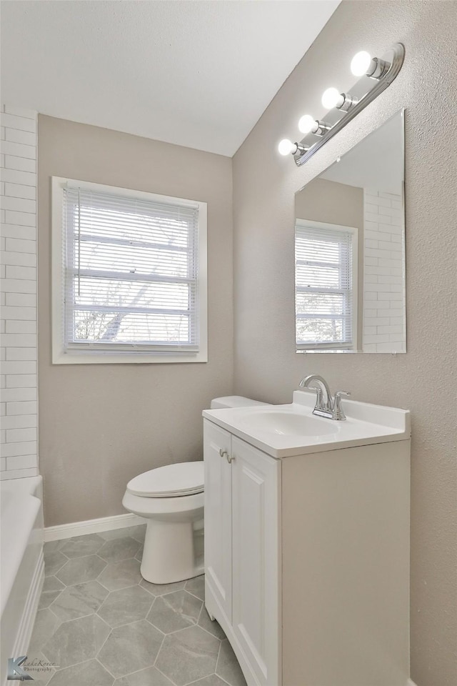 bathroom featuring toilet, tile patterned flooring, and vanity