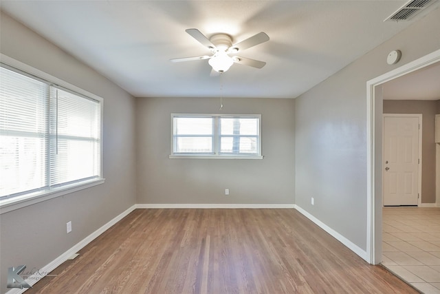 spare room with ceiling fan and light hardwood / wood-style floors