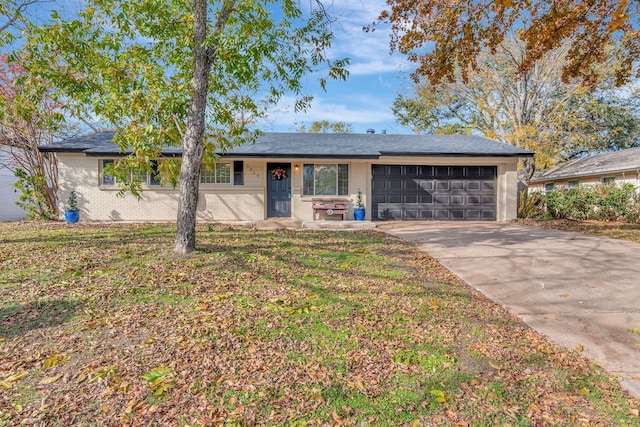 single story home with a garage and a front lawn