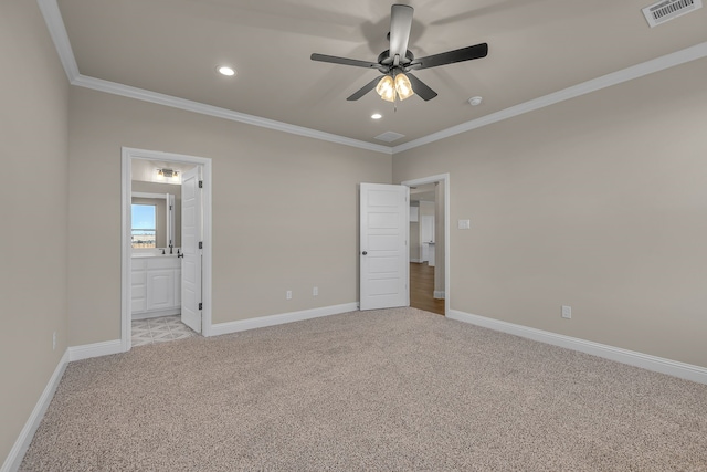 unfurnished bedroom with light colored carpet, ensuite bath, ceiling fan, and crown molding