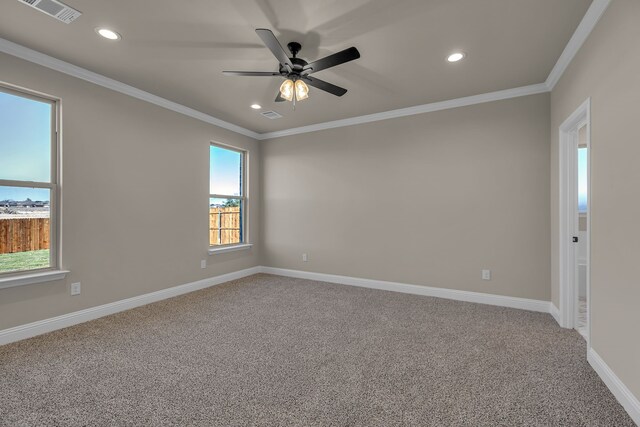 carpeted empty room with ceiling fan and ornamental molding