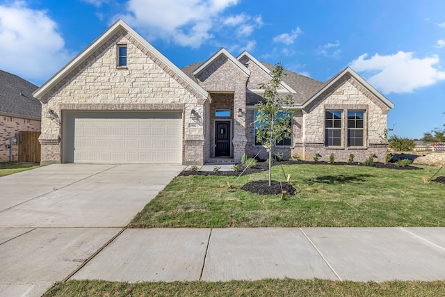 view of front of house featuring a garage and a front yard