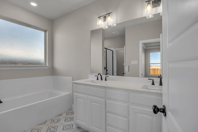 bathroom featuring vanity and independent shower and bath