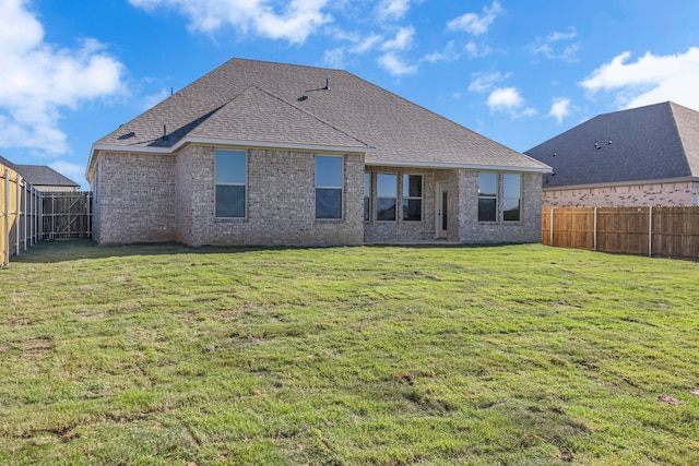 rear view of house with a yard