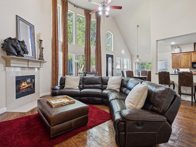 living room featuring hardwood / wood-style flooring, a fireplace, and high vaulted ceiling