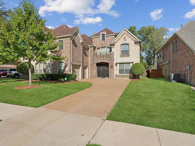 view of front of home with cooling unit, a garage, and a front lawn