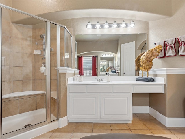 bathroom with vanity, tile patterned floors, and walk in shower