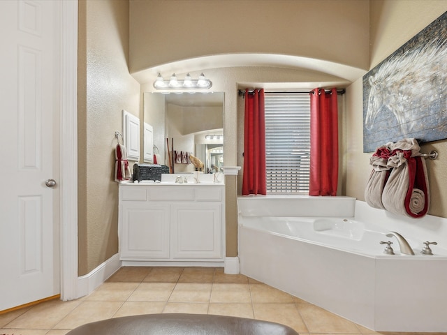 bathroom with vanity, tile patterned floors, and a tub to relax in