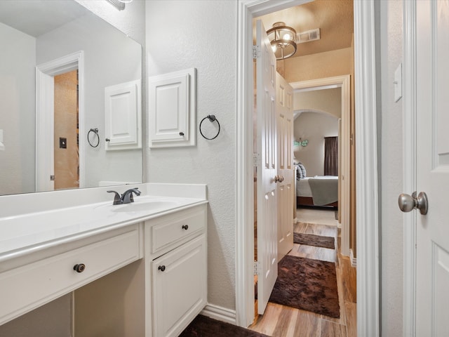 bathroom featuring hardwood / wood-style flooring and vanity