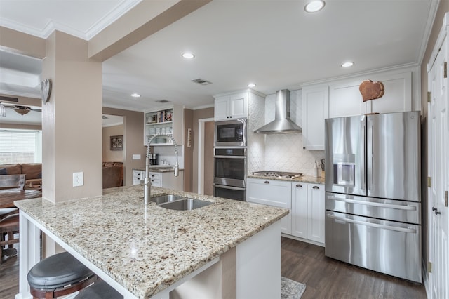 kitchen featuring white cabinetry, appliances with stainless steel finishes, wall chimney exhaust hood, and dark hardwood / wood-style floors