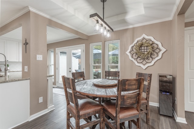 dining space with dark hardwood / wood-style floors, crown molding, and french doors