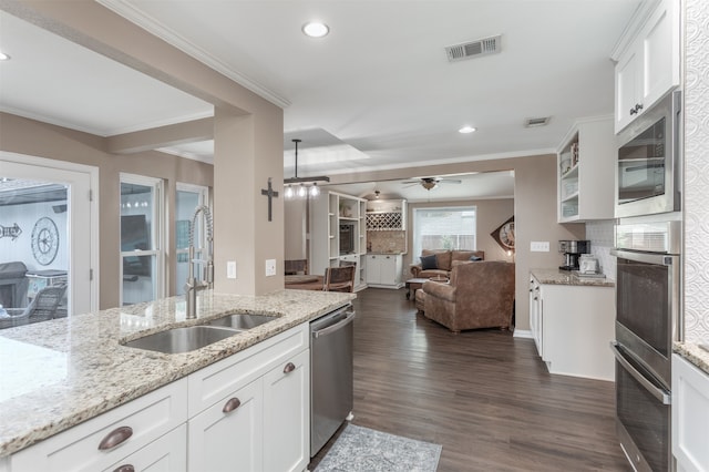 kitchen with light stone counters, sink, dark hardwood / wood-style floors, white cabinetry, and appliances with stainless steel finishes