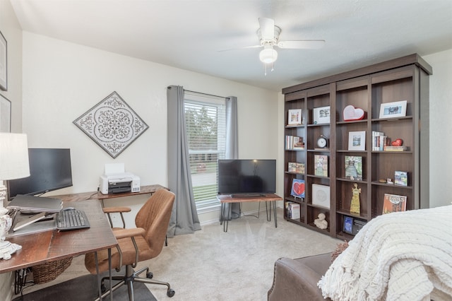 carpeted office space with ceiling fan