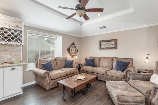 living room featuring ceiling fan, crown molding, dark hardwood / wood-style flooring, and a tray ceiling