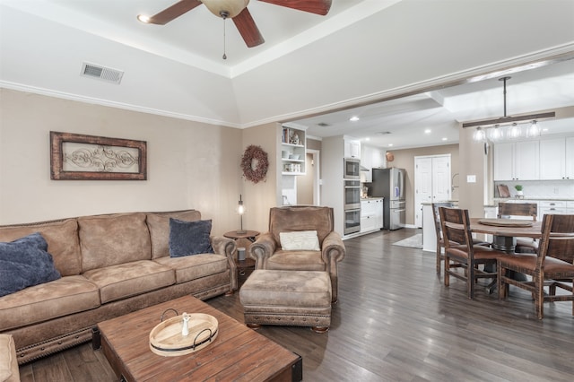 living room with ceiling fan, dark hardwood / wood-style flooring, and ornamental molding