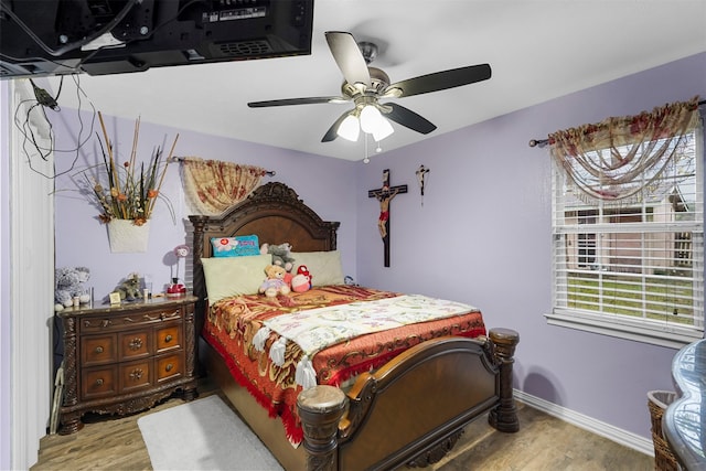 bedroom with hardwood / wood-style floors and ceiling fan