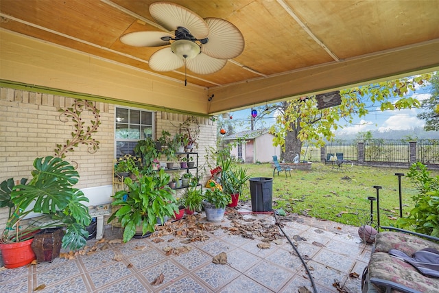 view of patio featuring a storage unit and ceiling fan