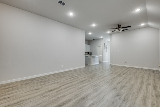 unfurnished living room with ceiling fan, lofted ceiling, and light hardwood / wood-style floors