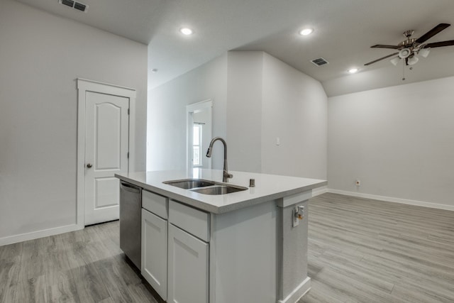 kitchen featuring stainless steel dishwasher, sink, a center island with sink, and light hardwood / wood-style flooring