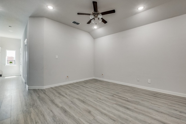 unfurnished room with light hardwood / wood-style floors, ceiling fan, a textured ceiling, and lofted ceiling