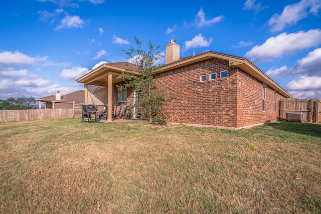 rear view of house featuring a lawn