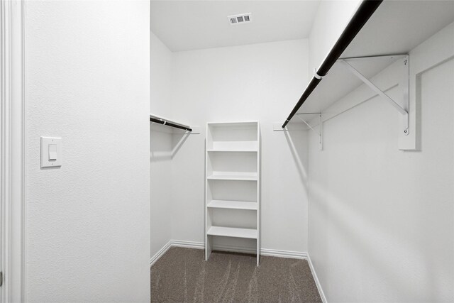 bedroom with ceiling fan, ensuite bathroom, and light colored carpet