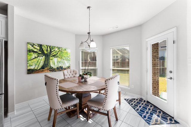 dining space featuring light tile patterned floors