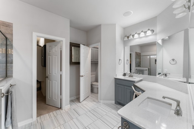 bathroom with walk in shower, tile patterned flooring, vanity, and toilet