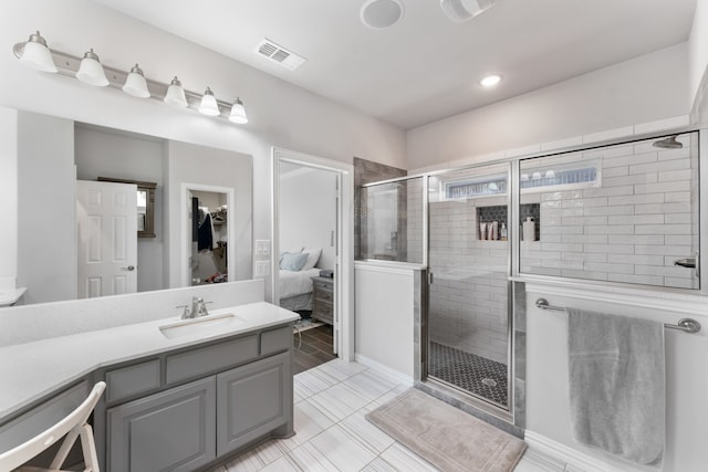 bathroom featuring vanity, tile patterned floors, and a shower with shower door