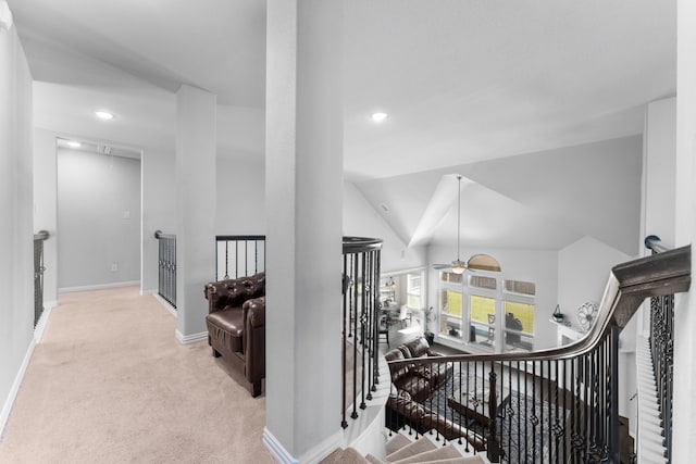 interior space featuring light carpet and vaulted ceiling