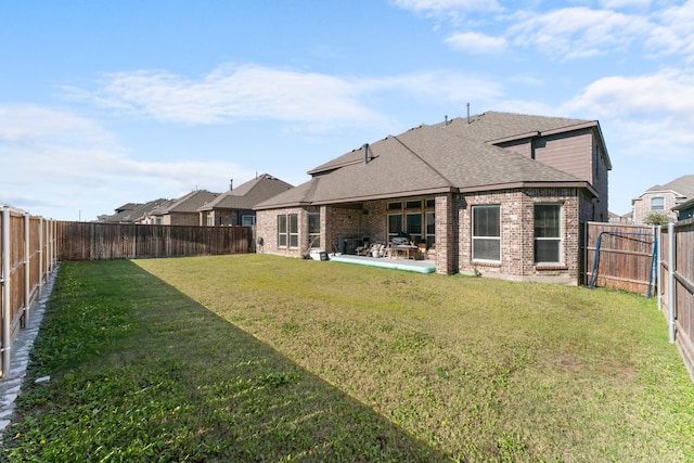 rear view of house with a lawn