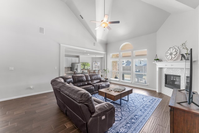 living room featuring dark hardwood / wood-style floors, high vaulted ceiling, and ceiling fan