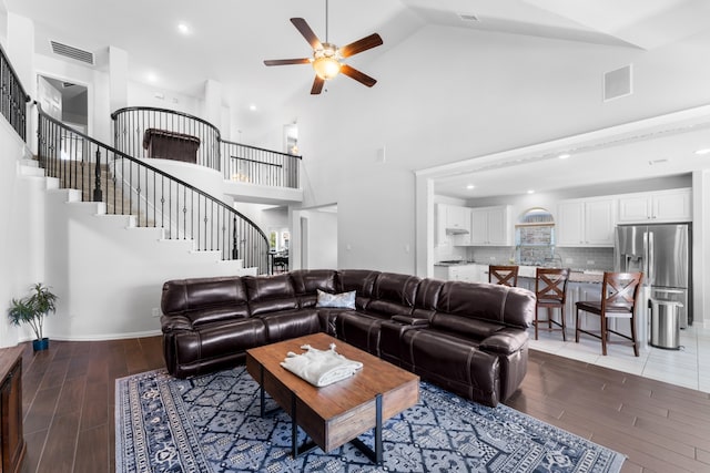 living room with hardwood / wood-style flooring, high vaulted ceiling, and ceiling fan