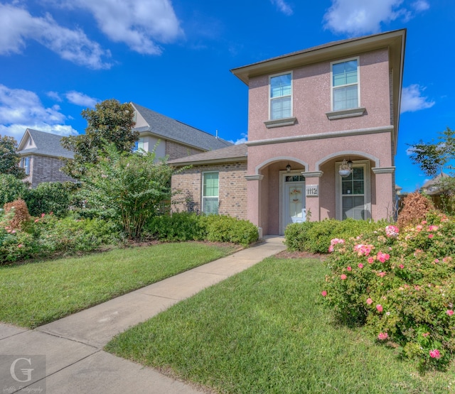 view of property featuring a front lawn