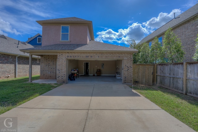 view of front of property with a garage and a front lawn