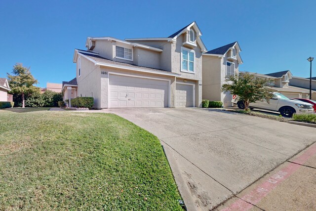 view of front property featuring a front lawn and a garage