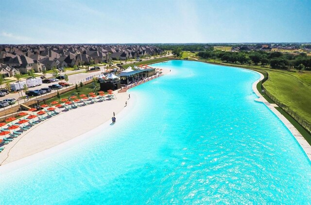 view of pool with a beach view and a water view