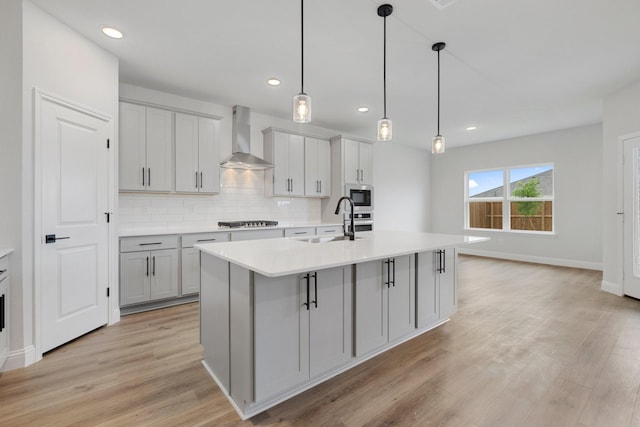 219 Briarwood Dr, Nevada, TX 75173 - kitchen featuring wall chimney range hood, appliances with stainless steel finishes, gray cabinets, light countertops, and recessed lighting