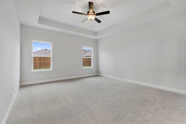 219 Briarwood Dr, Nevada, TX 75173 - unfurnished room with carpet floors, a tray ceiling, and a ceiling fan