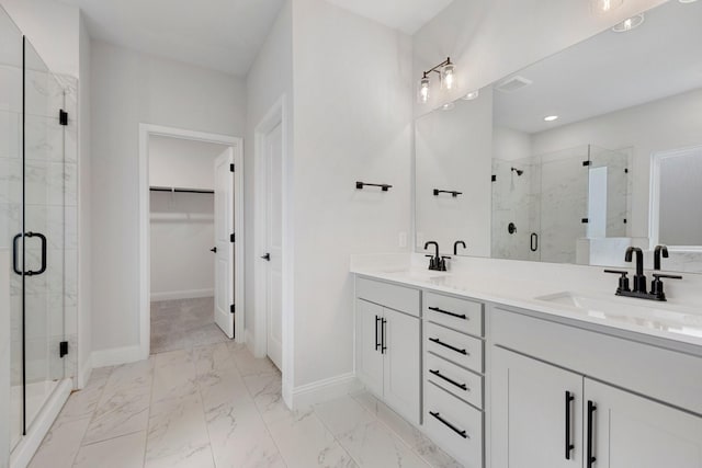 219 Briarwood Dr, Nevada, TX 75173 - bathroom featuring a shower stall, marble look tiles, double vanity, and a walk in closet