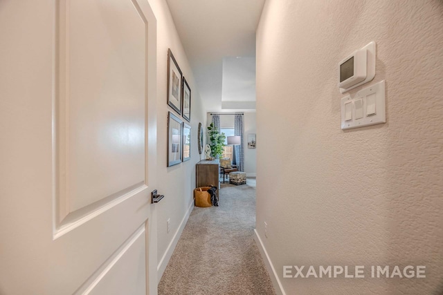 hallway featuring light colored carpet