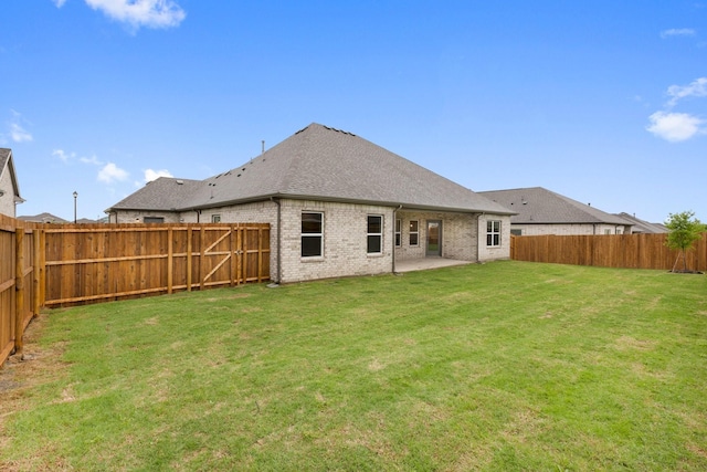 219 Briarwood Dr, Nevada, TX 75173 - back of house featuring brick siding, a fenced backyard, roof with shingles, and a patio
