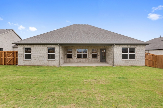 219 Briarwood Dr, Nevada, TX 75173 - rear view of property featuring roof with shingles, a fenced backyard, brick siding, and a patio