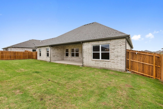 219 Briarwood Dr, Nevada, TX 75173 - back of property with a fenced backyard, roof with shingles, brick siding, and a patio