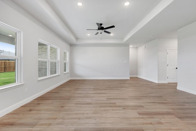 219 Briarwood Dr, Nevada, TX 75173 - unfurnished room with a ceiling fan, recessed lighting, a tray ceiling, and light wood-style flooring