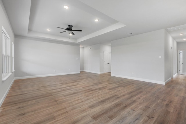 219 Briarwood Dr, Nevada, TX 75173 - empty room featuring a ceiling fan, wood finished floors, a raised ceiling, and recessed lighting