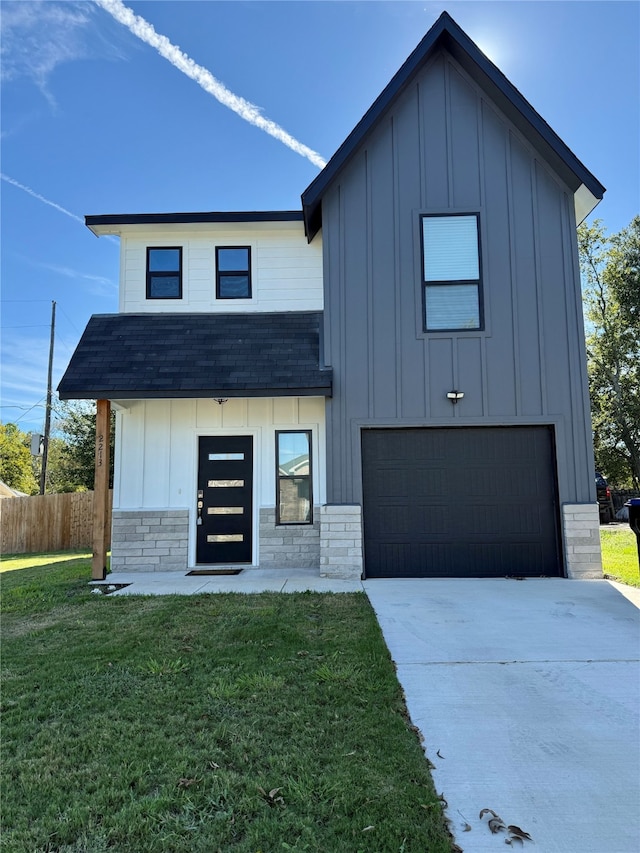 view of front of property with a garage and a front yard