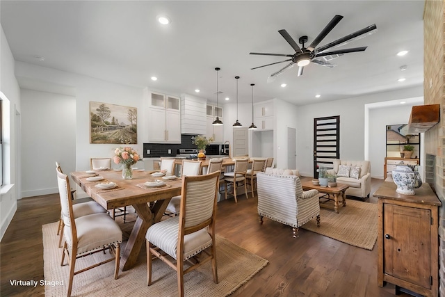 dining area with ceiling fan and dark hardwood / wood-style floors