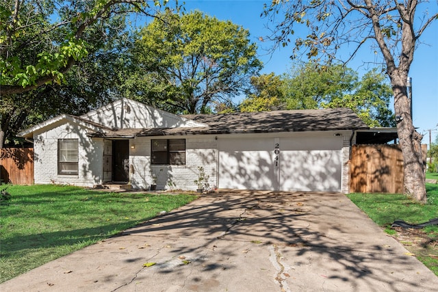 single story home featuring a garage and a front yard