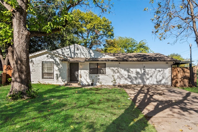 ranch-style house featuring a front lawn and a garage